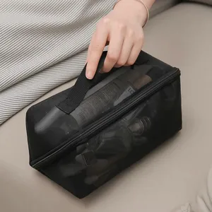 Black mesh cosmetic bag with handle, large capacity portable travel makeup storage pouch.