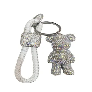 Portachiavi orsetto con strass carino con cinturino in pelle intrecciata bianca per chiavi e borse.