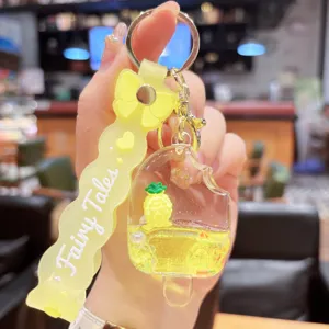 Detailed close-up of the yellow quicksand pineapple popsicle keychain with cute glitter liquid.