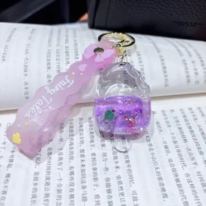 Cute acrylic quicksand keychain pendant with liquid glitter floating charm for bags.