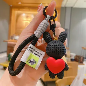 Cute resin cartoon rabbit keychain with red heart pendant, stylish bag charm and key chain.