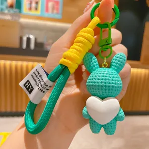 Cute resin rabbit keychain with heart charm, stylish bag pendant and car key ring accessory.