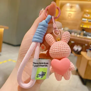 Cute resin knit rabbit keychain with heart pendant, blue lanyard detail, bag charm accessory.