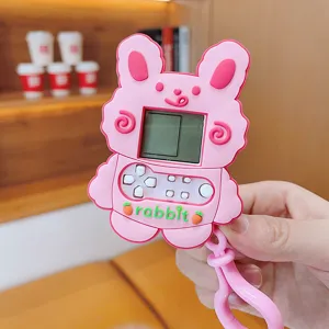Pink rabbit electronic handheld game console keychain with silicone cute toy design details.