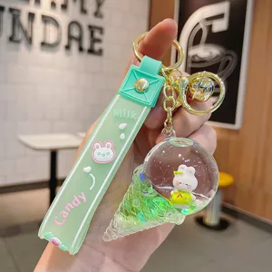 Cute floating liquid ice cream rabbit keychain detail shot, green strap, gold hardware.