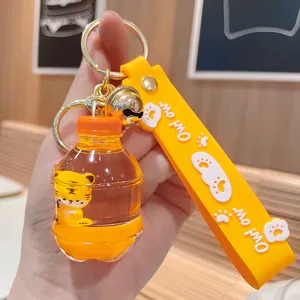 Süßer flüssiger schwimmender Tiger Schlüsselanhänger mit Band und Glocke, transparente Ölflasche.