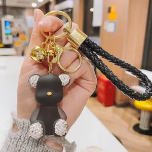 Detailed view of the cute rhinestone jelly bear keychain with braided leather strap and bell.