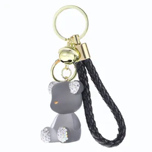 Cute grey jelly bear keychain with sparkling rhinestones, premium metal ring and braided leather strap.