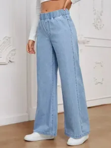 Details of the light blue wide leg jeans paired with elastic waist and casual indoor setting.