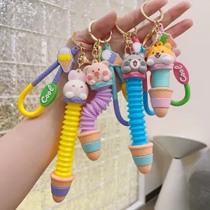 Detailed view of cute cartoon animal ice cream pop tube keychains, colorful bag pendants.