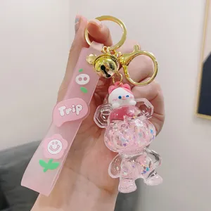 Cute pink quicksand bear keychain with bell, perfect accessory for car keys, bags and gifts.