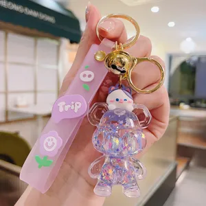 Cute cartoon quicksand bear keychain with cat pendant, stylish bag charm and key ring.