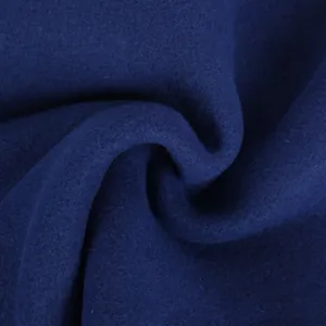 Dark blue wool blanket fabric detail showing soft thick textured material for cozy warmth.