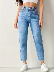 Detailed view of women's high-waisted washed blue jeans, slim fit denim trousers for casual wear.