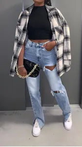 Stylish streetwear light blue ripped straight leg jeans with front slit for women fashion trend.