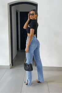 Detailed view of women's light blue straight leg split jeans, casual streetwear style.