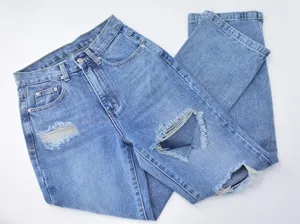 Blue ripped straight leg jeans detail, distressed denim fabric, casual street style pants.