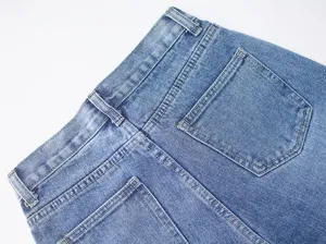 Close-up detail of women's denim jeans back pocket and waistband, classic blue wash.