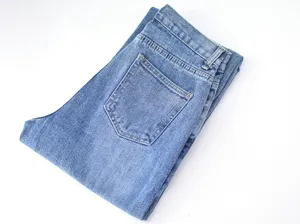 Detailed view of women's classic blue denim jeans featuring back pocket design and clean wash.