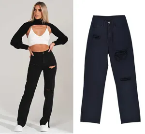 Close-up details of black straight-leg denim jeans featuring stylish knee distressing and hem slits.
