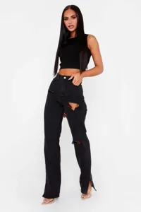 Black ripped straight leg jeans with front slit detail paired with a simple black crop top.