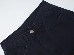 Women's denim jeans waist detail shot, classic dark blue jeans with high waist design.