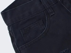 Detailed view of women's dark denim jeans pocket and waistband design, stylish street style.