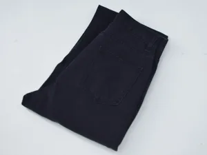 Black denim jeans detail shot showing pocket and fabric texture, casual wear basic style.