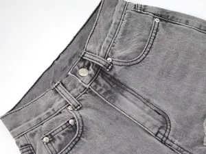Women grey denim jeans waistband detail, casual straight trousers with metal button styling.