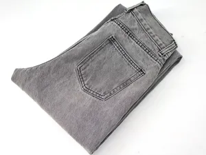 Detailed view of women gray denim jeans showing back pocket and folded design.