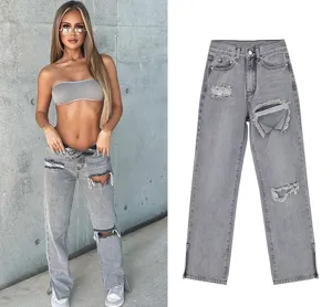 Grey distressed straight leg jeans detail, showcasing ripped knee and slit hem design features.