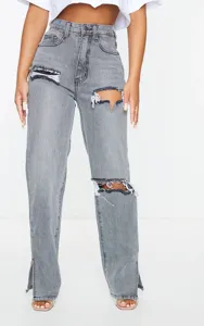 Detailed view of high waisted acid wash grey straight leg jeans with slit hem and knee rips.