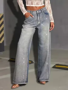 Close-up detail of women's wide-leg jeans featuring sparkling rhinestone embellishments.
