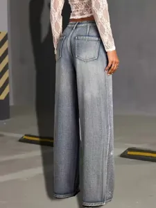 High-waisted wide-leg denim jeans featuring rhinestone side details and distressed wash finish.