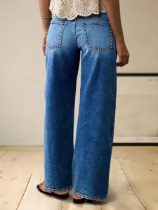 Close-up detail of women casual blue wide leg denim pants with back pocket design.