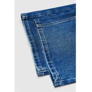Classic blue denim jeans hem detail, casual style, versatile everyday wardrobe essential.