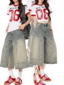 Vintage wide leg denim capris for women, loose washed jeans with graphic t-shirt outfit.