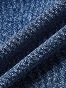 Detailed shot of dark blue denim fabric with classic twill texture, ideal for jeans.