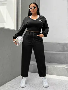 Detailed view of women's black high waist washed denim jeans, casual plus size trouser style.