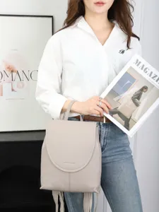 Minimalist genuine leather backpack in light grey for women, stylish casual daypack.