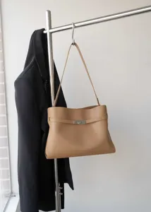Classic retro camel leather shoulder bag detail, elegant minimalist design with metal clasp.