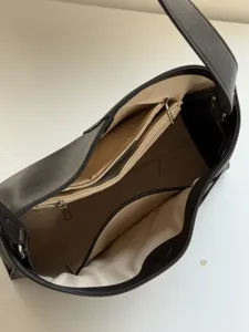 Detailed view of the black retro slouchy Kelly shoulder bag, showing internal compartments.