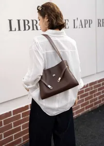 Retro lazy style brown leather underarm shoulder bag with metal lock detail, detail view.