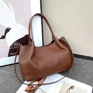 Detailed view of the brown genuine leather shoulder bag, showcasing fine texture and design.