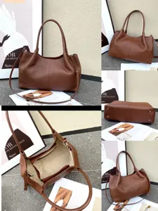 Detailed view of the brown genuine leather hobo bag, showing interior and hardware.