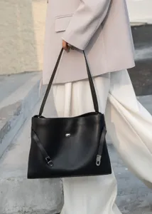 Classic black leather shoulder bag with chic metal lock and minimalist design for women.