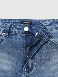 Close up view of women classic blue denim jeans zipper and waistband detail with label.