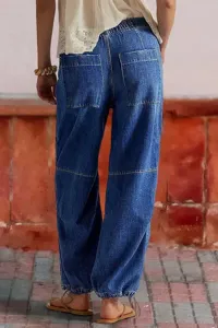 Detailed back view of women's blue denim wide-leg pants with cinched cuffs and pockets.