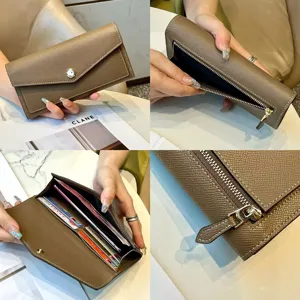 Brown genuine leather long wallet for women with zipper coin pocket and chic turn-lock closure.