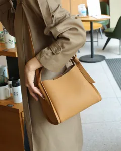Premium leather shoulder bag for women, stylish bucket handbag with comfortable strap, casual tan design.